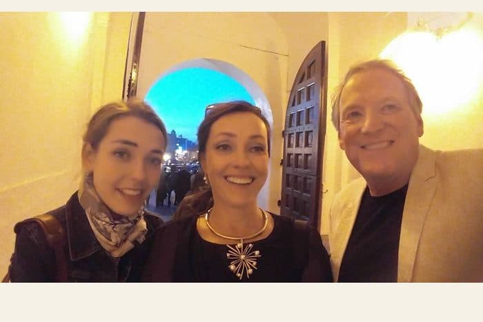 Three people in a doorway - the photograph, and the watercolour painted from it