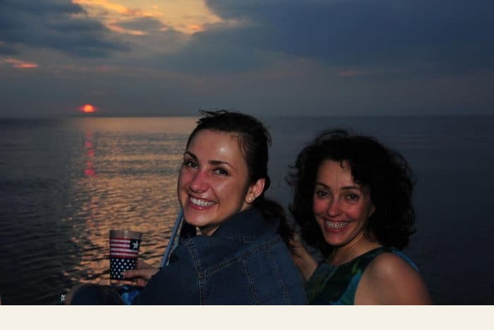 Two women by the sea at sunset - the photograph, and the watercolour painted from it