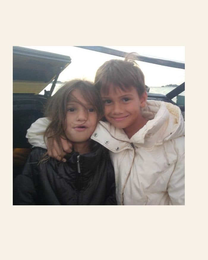 Two children arm in arm - the photograph, and the watercolour painted from it