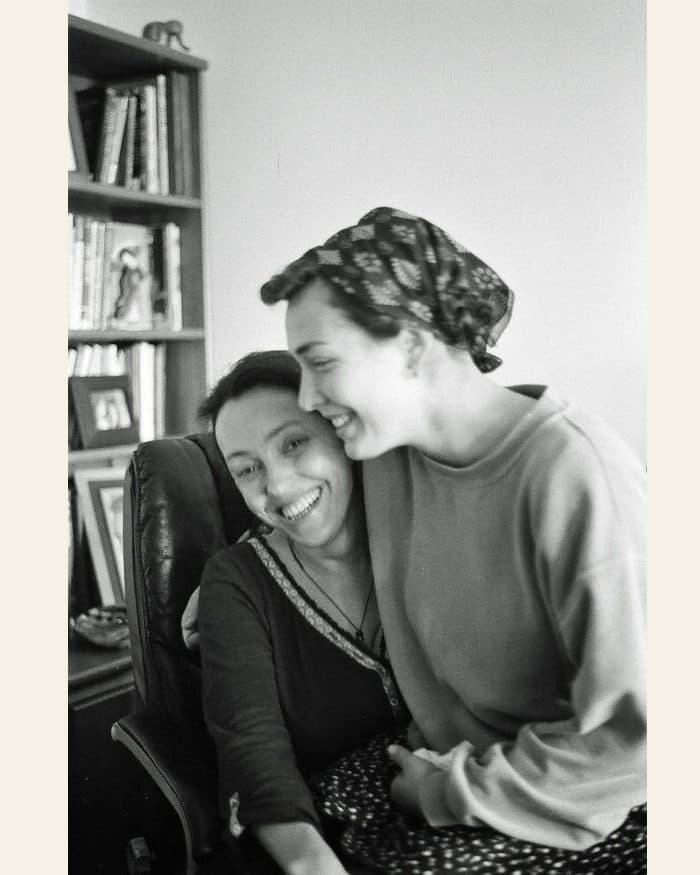 A mother and her grown daughter laughing - the photograph, and the pencil portrait drawn from it